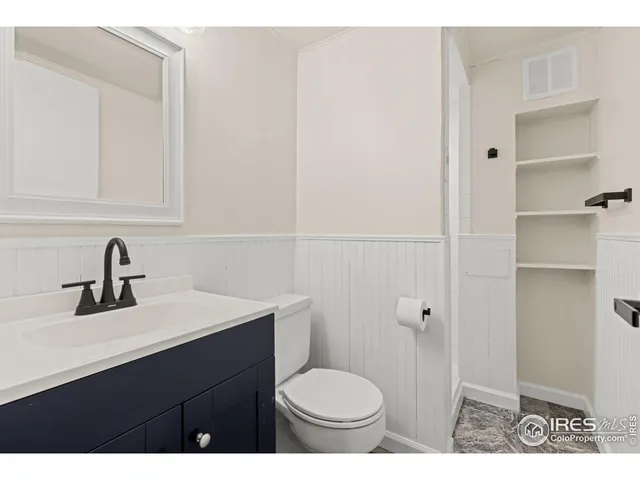 a bathroom with a sink toilet and vanity