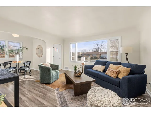 a living room with furniture window and wooden floor