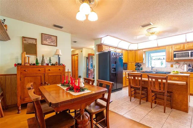 a view of a dining room with furniture and a chandelier