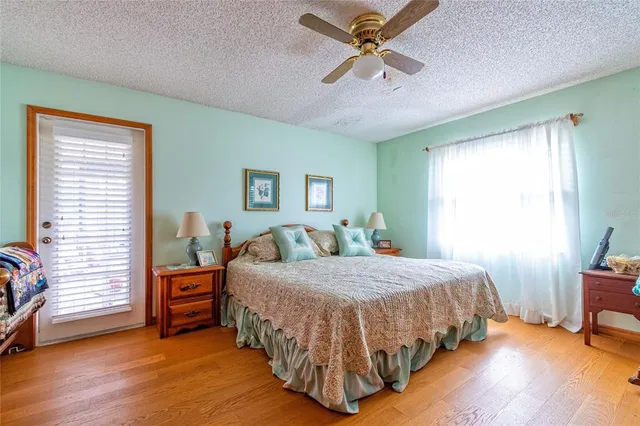 a bedroom with a bed a chandelier and a window
