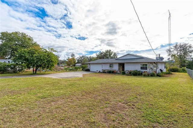 a front view of house with yard and trees