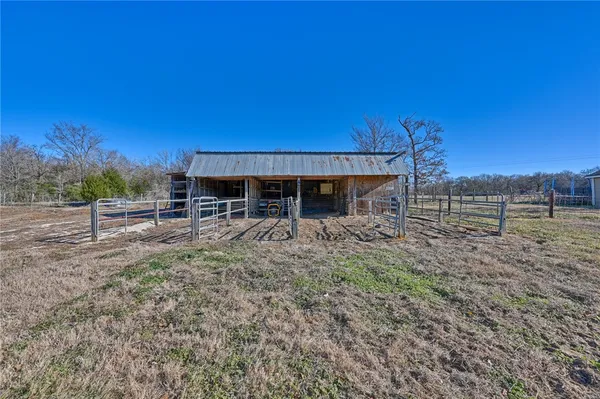 an aerial view of house with yard and mountain view in back