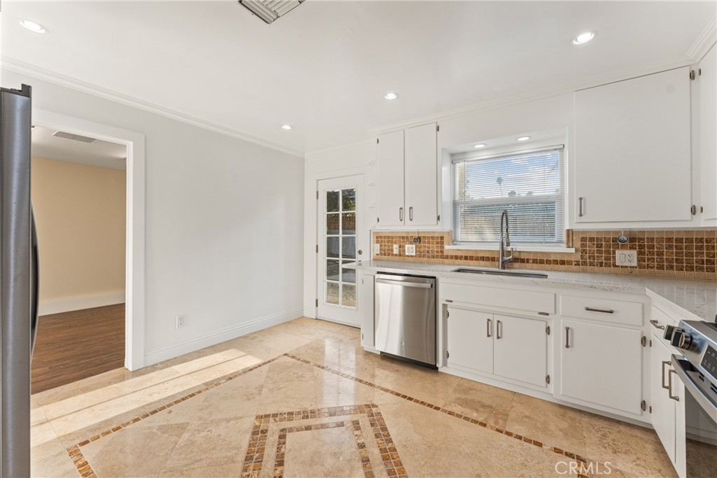 510 Lime Street Redlands, CA 92374 - Photo 17 of 50 a kitchen with white cabinets and sink