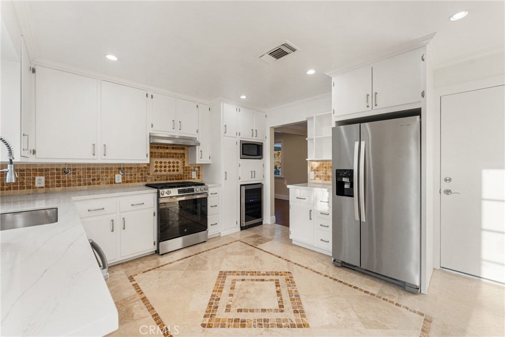 510 Lime Street Redlands, CA 92374 - Photo 19 of 50 a kitchen with white cabinets and stainless steel appliances