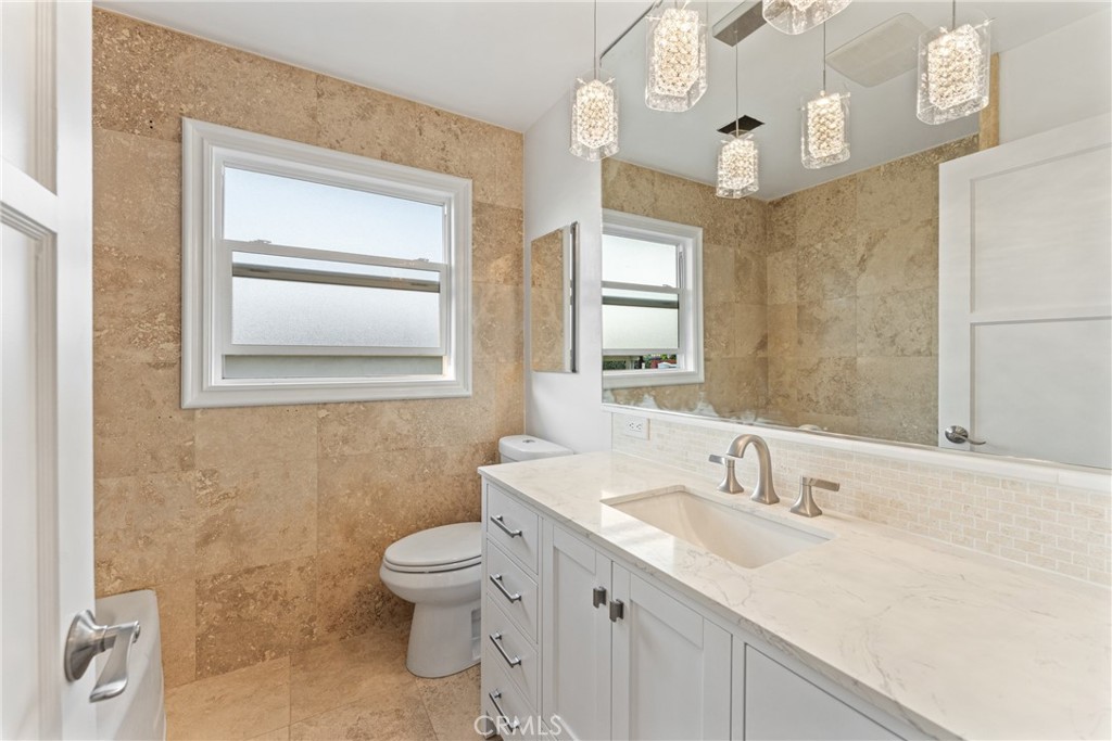 510 Lime Street Redlands, CA 92374 - Photo 26 of 50 a bathroom with a sink a toilet and a mirror