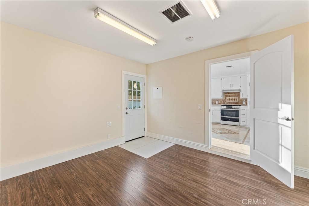 510 Lime Street Redlands, CA 92374 - Photo 29 of 50 an empty room with wooden floor cabinet and windows