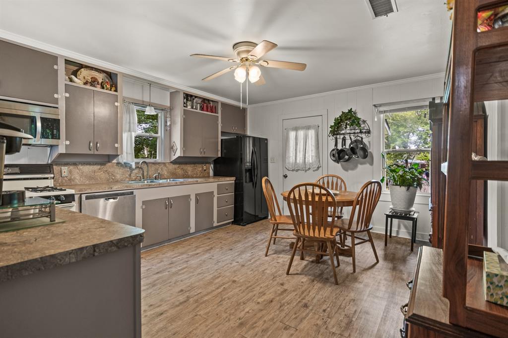 103 South Sun Camp Road White Oak, TX 75693 - Photo 14 of 40 a view of a dining room with furniture and chandelier