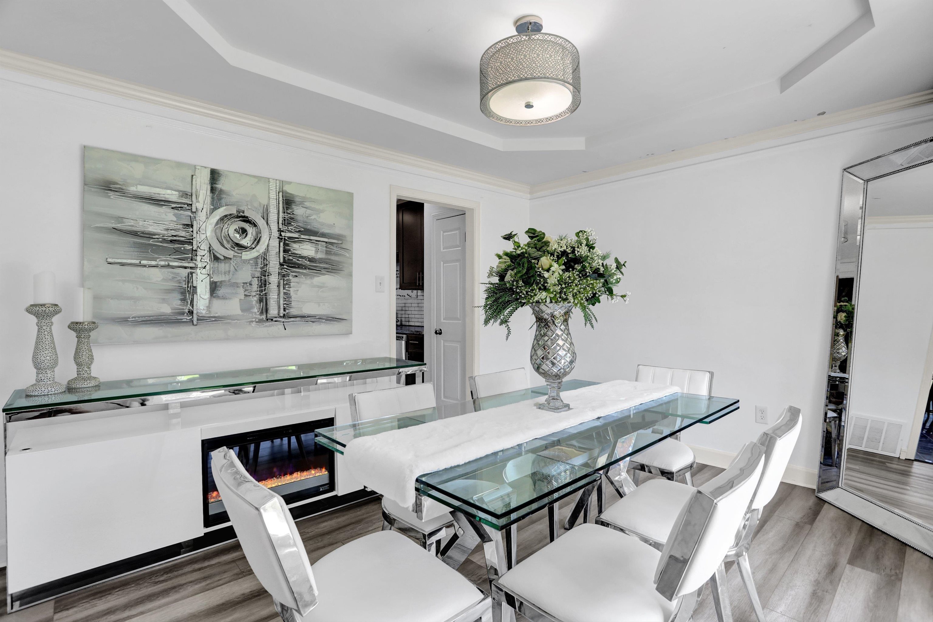 a view of a kitchen area with furniture and wooden floor