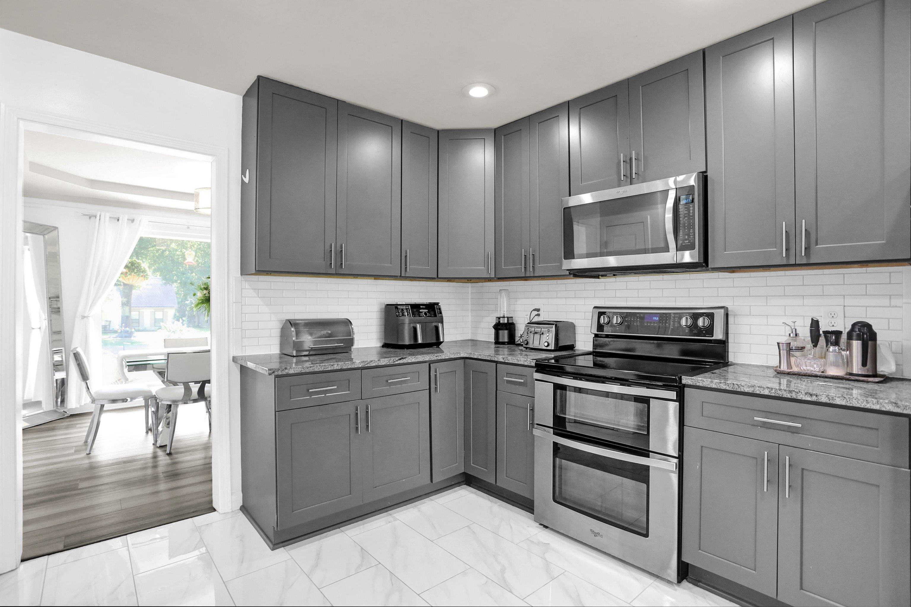 4045 Bartlett Country Road Bartlett, TN 38135 - Photo 15 of 40 a kitchen with stainless steel appliances granite countertop wooden cabinets a sink a stove a dining table and chairs