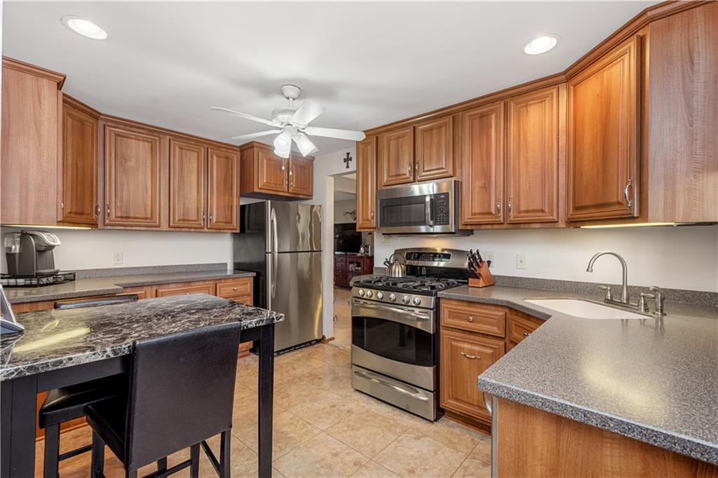 1735 Borland Road Pittsburgh, PA 15243 - Photo 6 of 25 a kitchen with a stove a sink a microwave and refrigerator