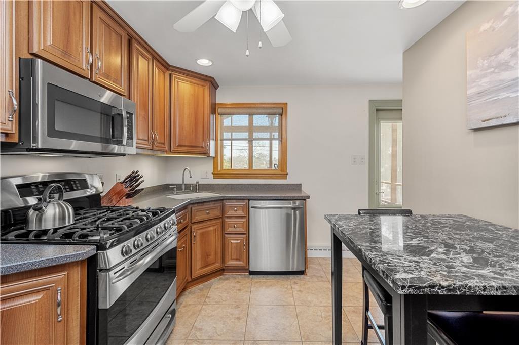 1735 Borland Road Pittsburgh, PA 15243 - Photo 7 of 25 a kitchen with stainless steel appliances granite countertop a stove a sink and a microwave