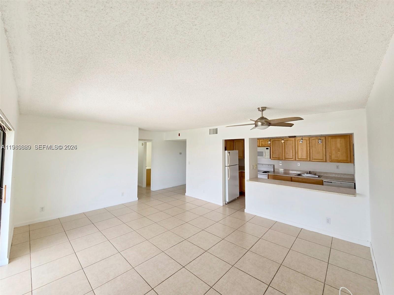 505 South Pine Island Road, Unit 401B Plantation, FL 33324 - Photo 4 of 15 an empty room with kitchen view