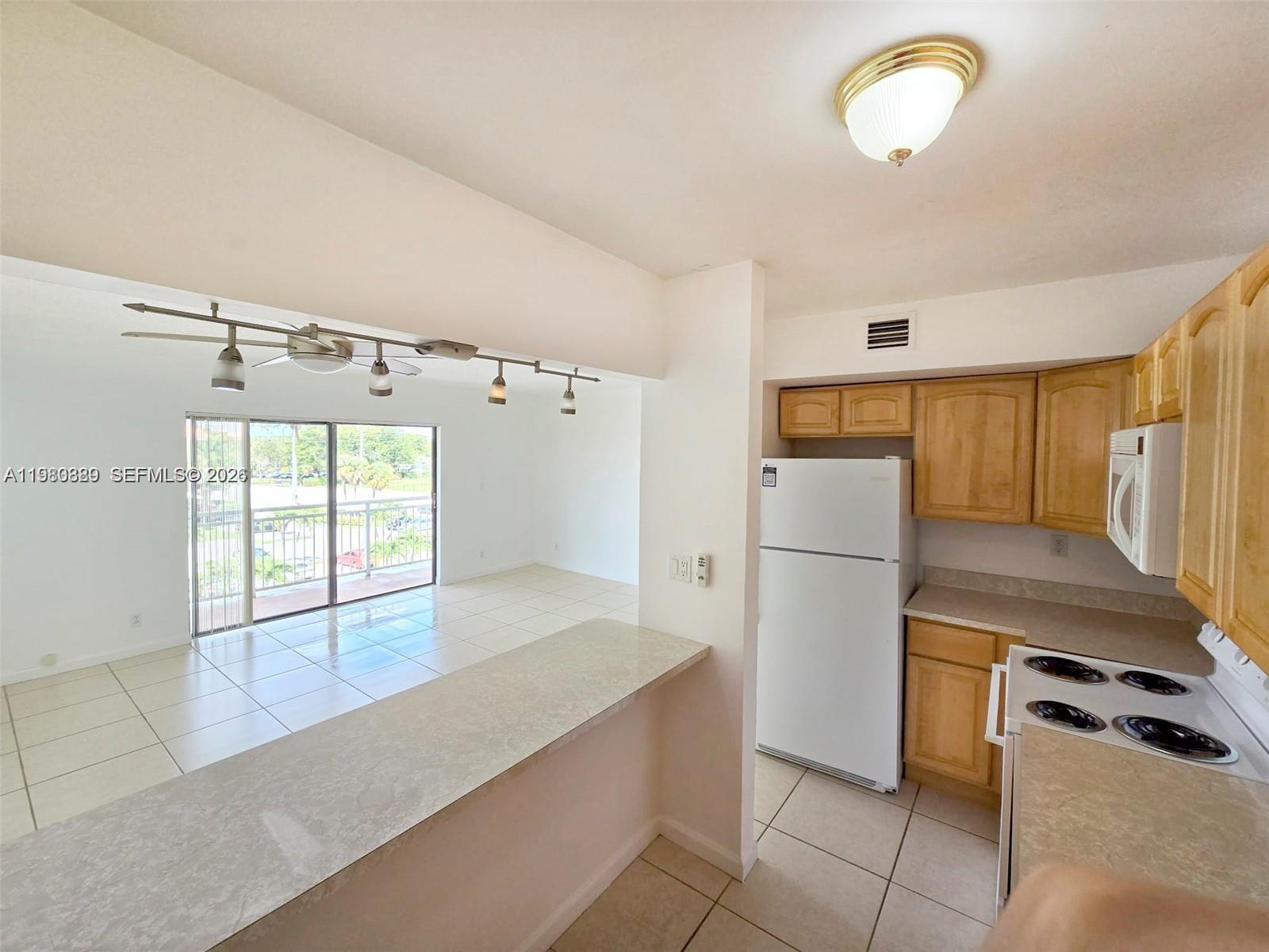505 South Pine Island Road, Unit 401B Plantation, FL 33324 - Photo 6 of 15 a kitchen with granite countertop a refrigerator and a stove