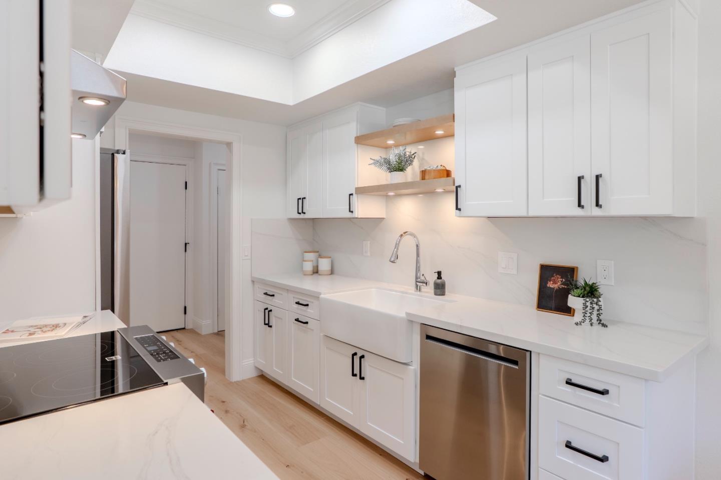 22330 Homestead Road, Unit 116 Cupertino, CA 95014 - Photo 10 of 30 a kitchen with stainless steel appliances white cabinets and a sink