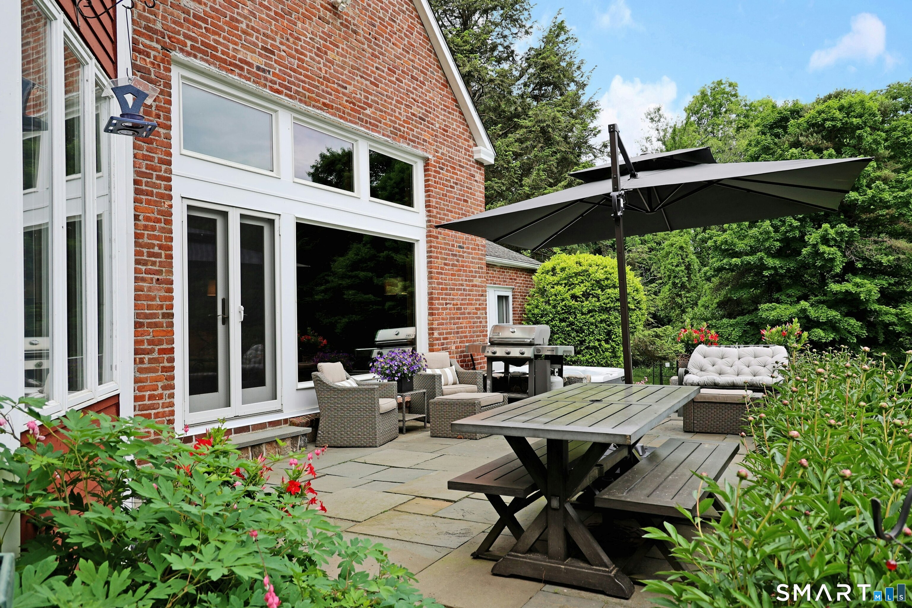 68 Bloomer Road Ridgefield, CT 06877 - Photo 5 of 40 a view of a patio with table and chairs under an umbrella