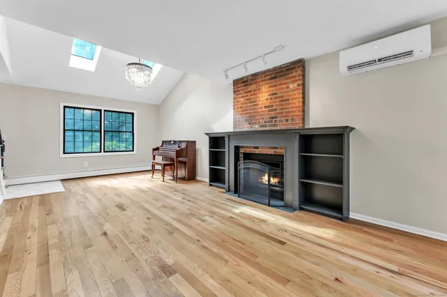 a view of empty room with a fireplace and window