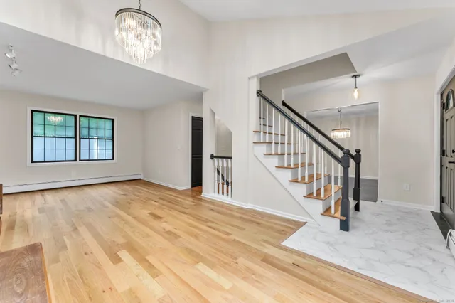 a view of an entryway with wooden floor