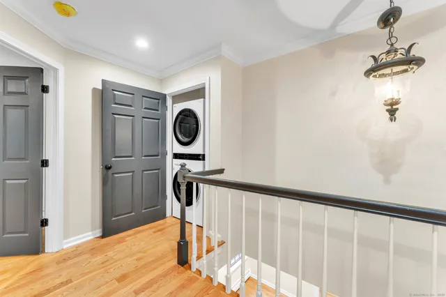 a view of a hallway with wooden floor and furniture