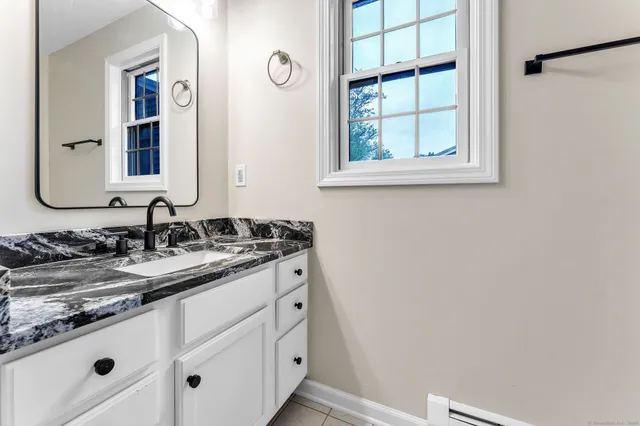 a bathroom with a sink and a mirror