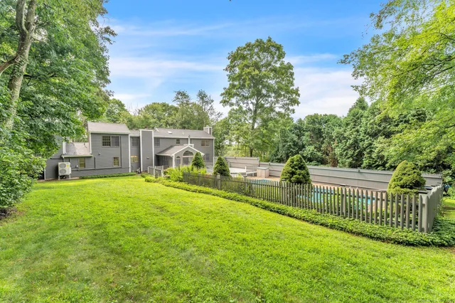 a view of a house with a yard and a garden