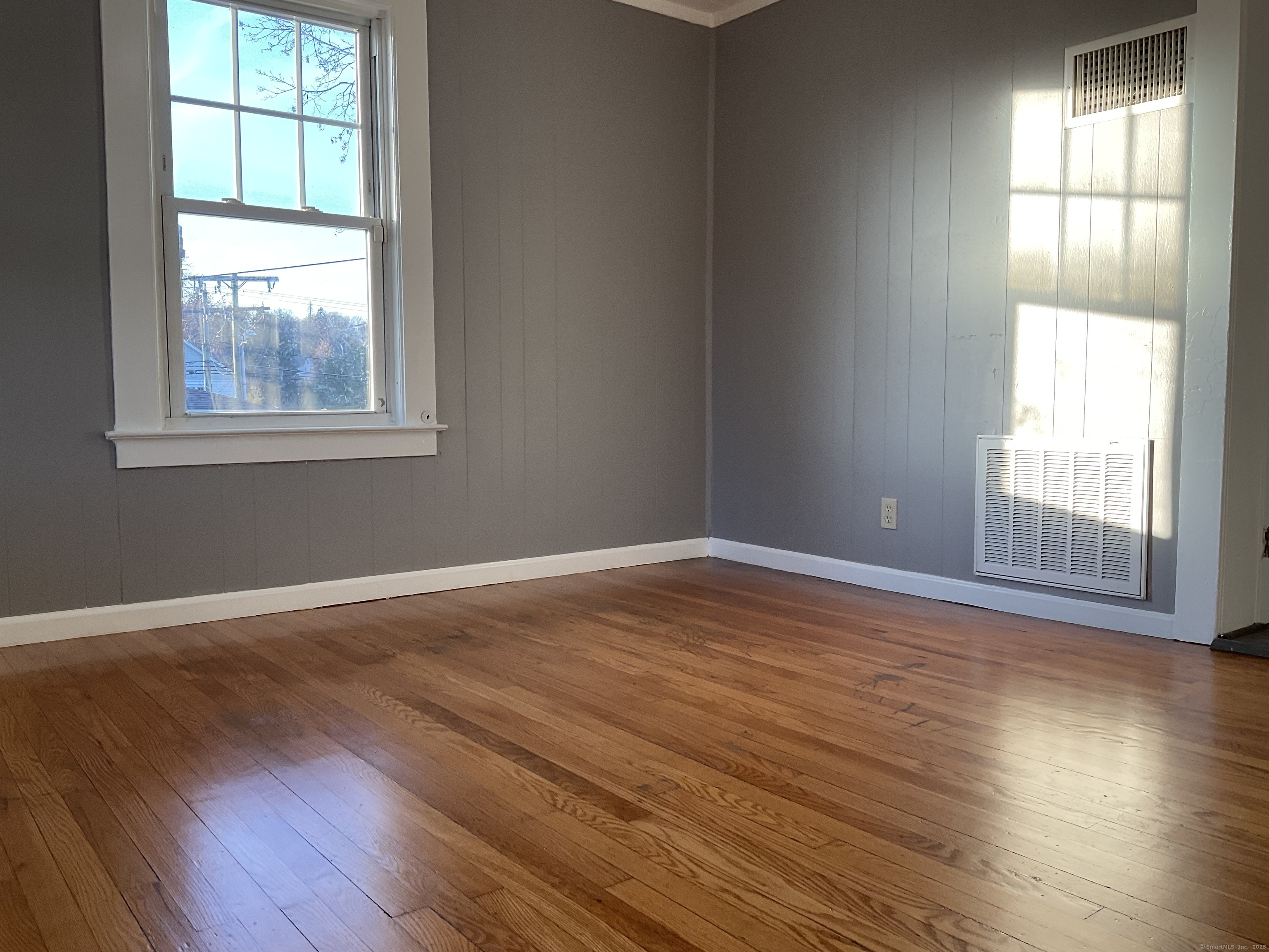 16 Lake Street, Unit 2W Middletown, CT 06457 - Photo 12 of 15 an empty room with wooden floor and windows