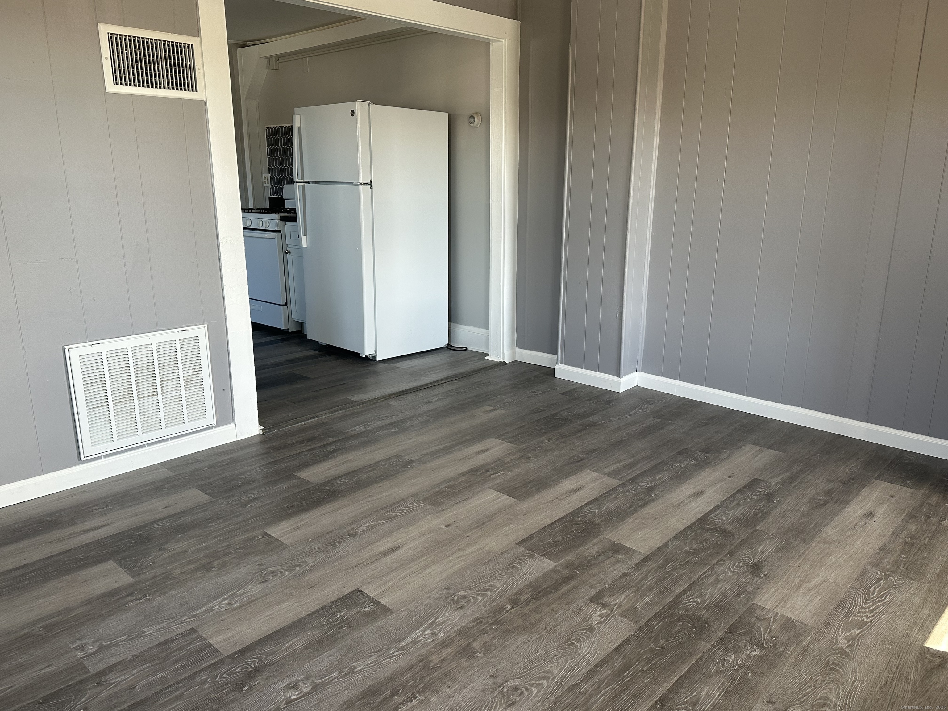 16 Lake Street, Unit 2W Middletown, CT 06457 - Photo 15 of 15 an empty room with wooden floor and a refrigerator
