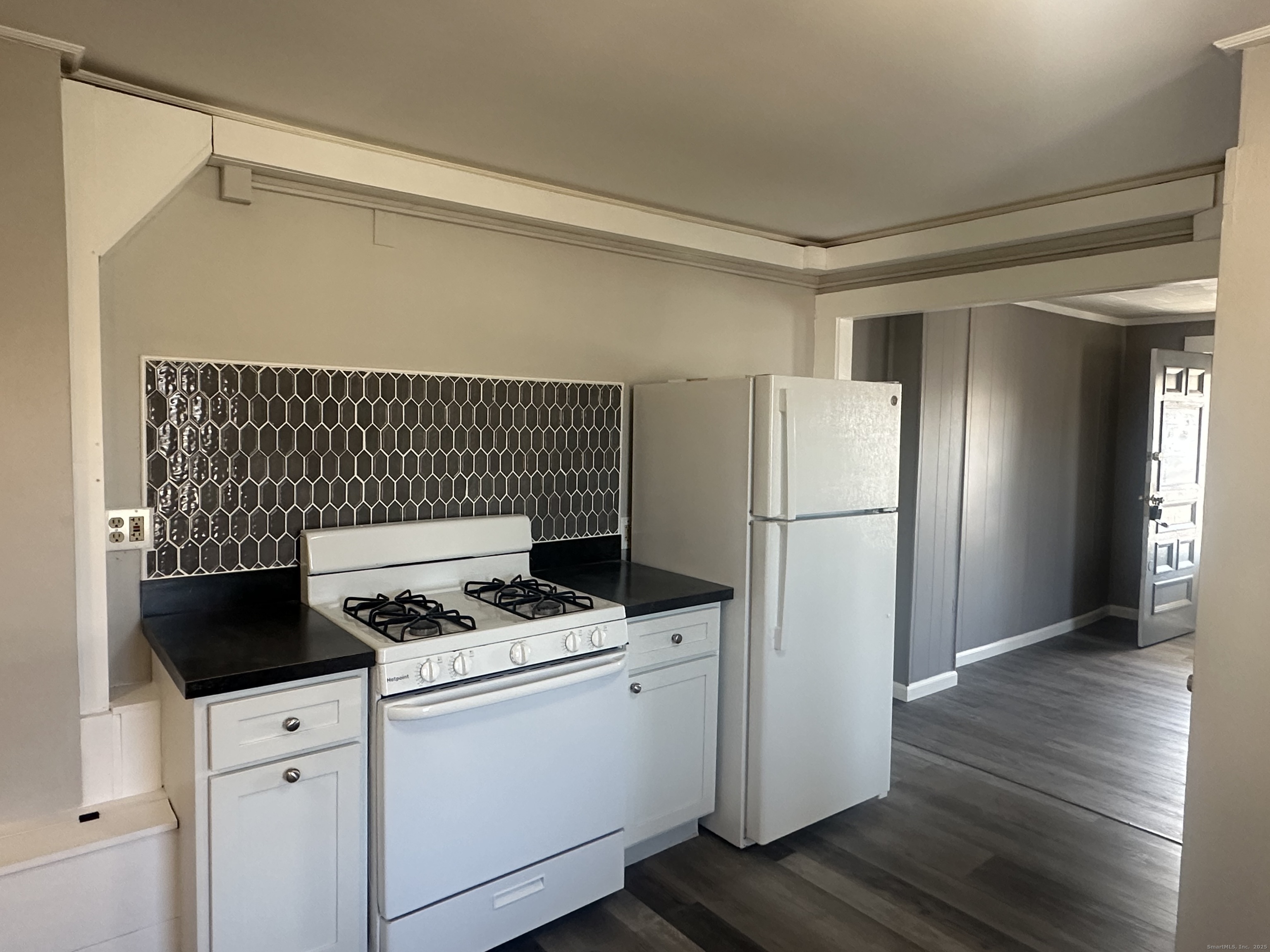 16 Lake Street, Unit 2W Middletown, CT 06457 - Photo 3 of 15 a kitchen with a refrigerator and white cabinets