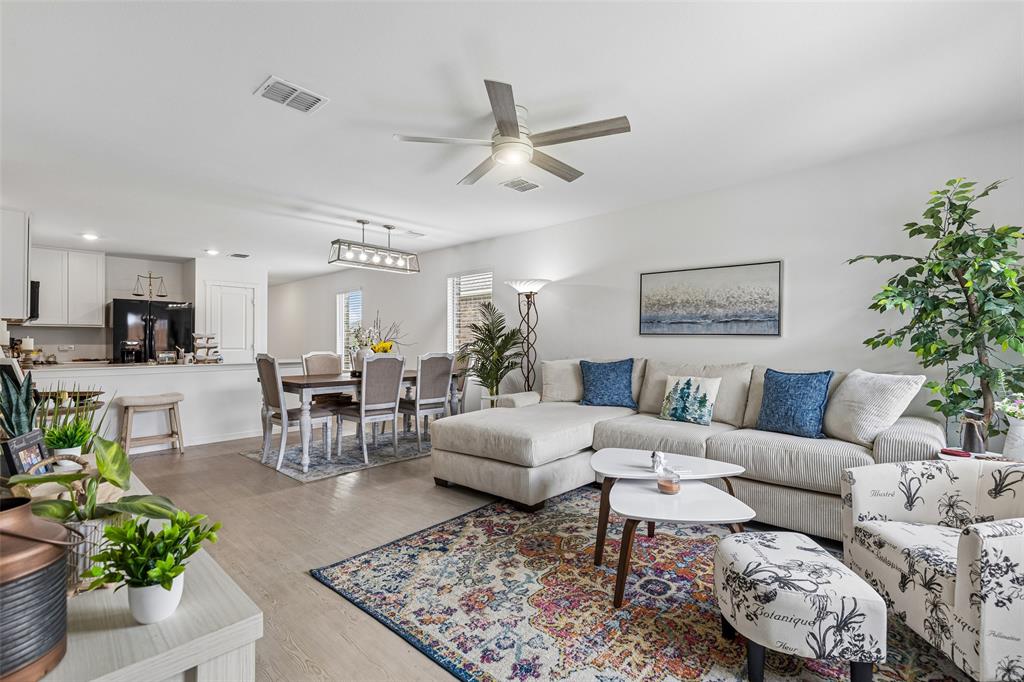 14163 Kempt Drive Pilot Point, TX 76258 - Photo 10 of 29 The bright and airy living room offers generous space for relaxing and entertaining while maintaining an open connection to the kitchen and dining areas.