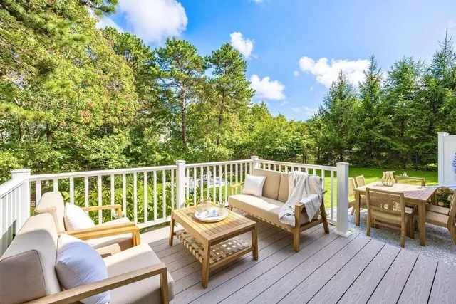 a balcony with table and chairs