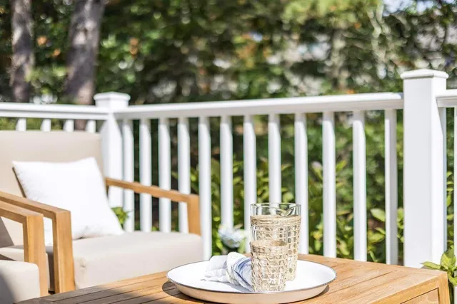 a kitchen with stainless steel appliances granite countertop a sink a stove a refrigerator and island with wooden floor