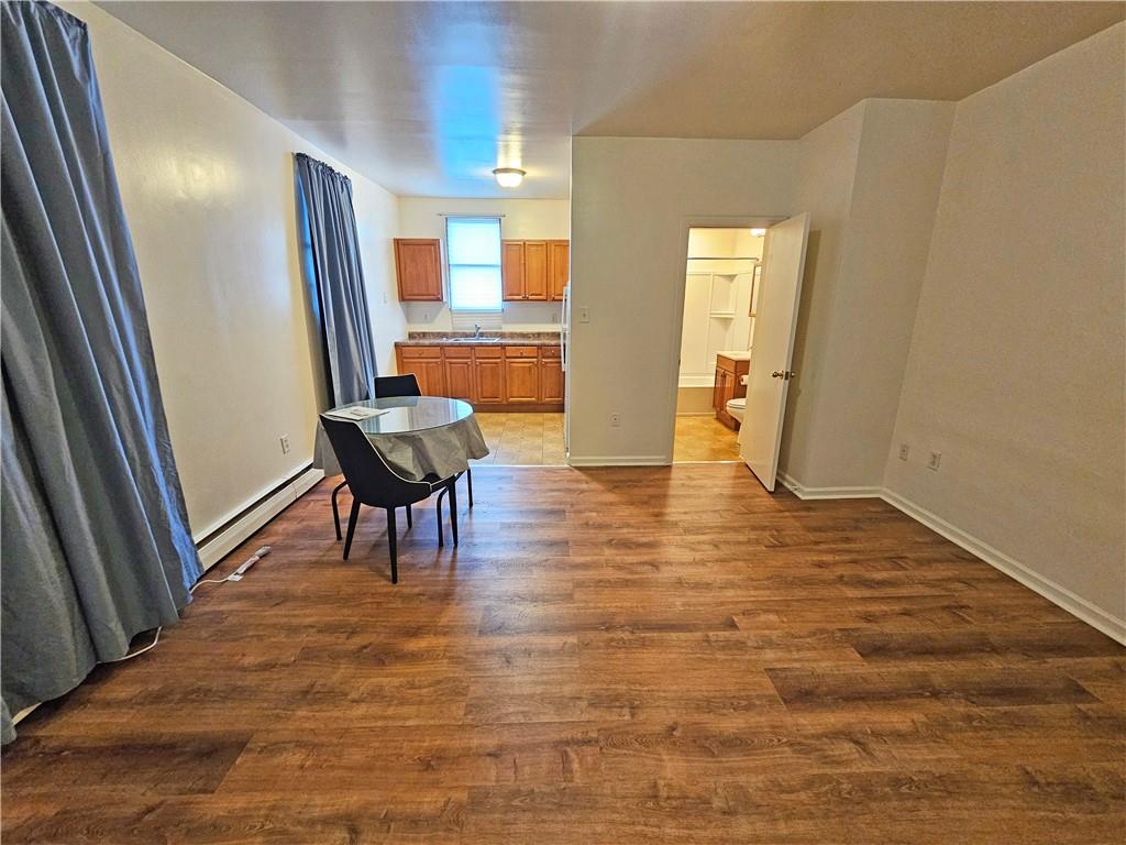 a view of a hallway with furniture and wooden floor