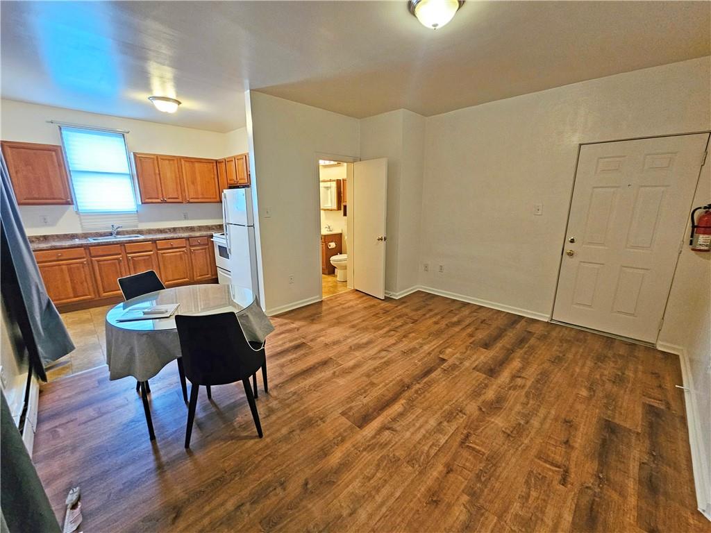 944 4th Avenue, Unit 4 Coraopolis, PA 15108 - Photo 2 of 6 a workspace room with wooden floor table and chair