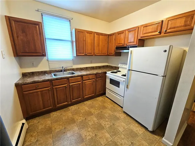 a kitchen with stainless steel appliances granite countertop a refrigerator sink and cabinets