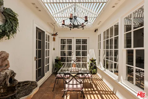 a view of a porch with wooden floor and furniture