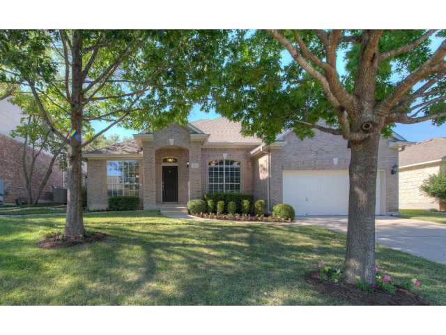 7112 Wandering Oak Road Austin, TX 78749 - Photo 1 of 1 a front view of a house with a garden and trees