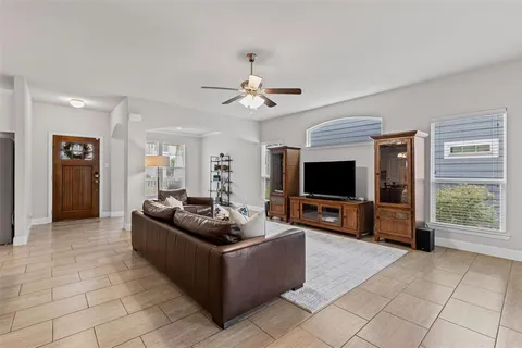 a view of a dining room with furniture a chandelier and wooden floor