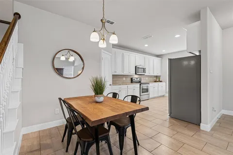 a view of a livingroom with furniture and a flat screen tv