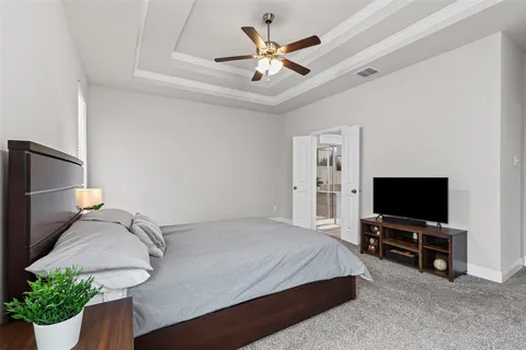 a bedroom with a bed and a chandelier