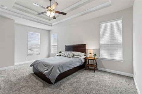 a spacious bathroom with a bathtub double sink and mirror