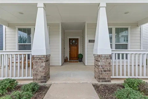 a living room with furniture and a refrigerator