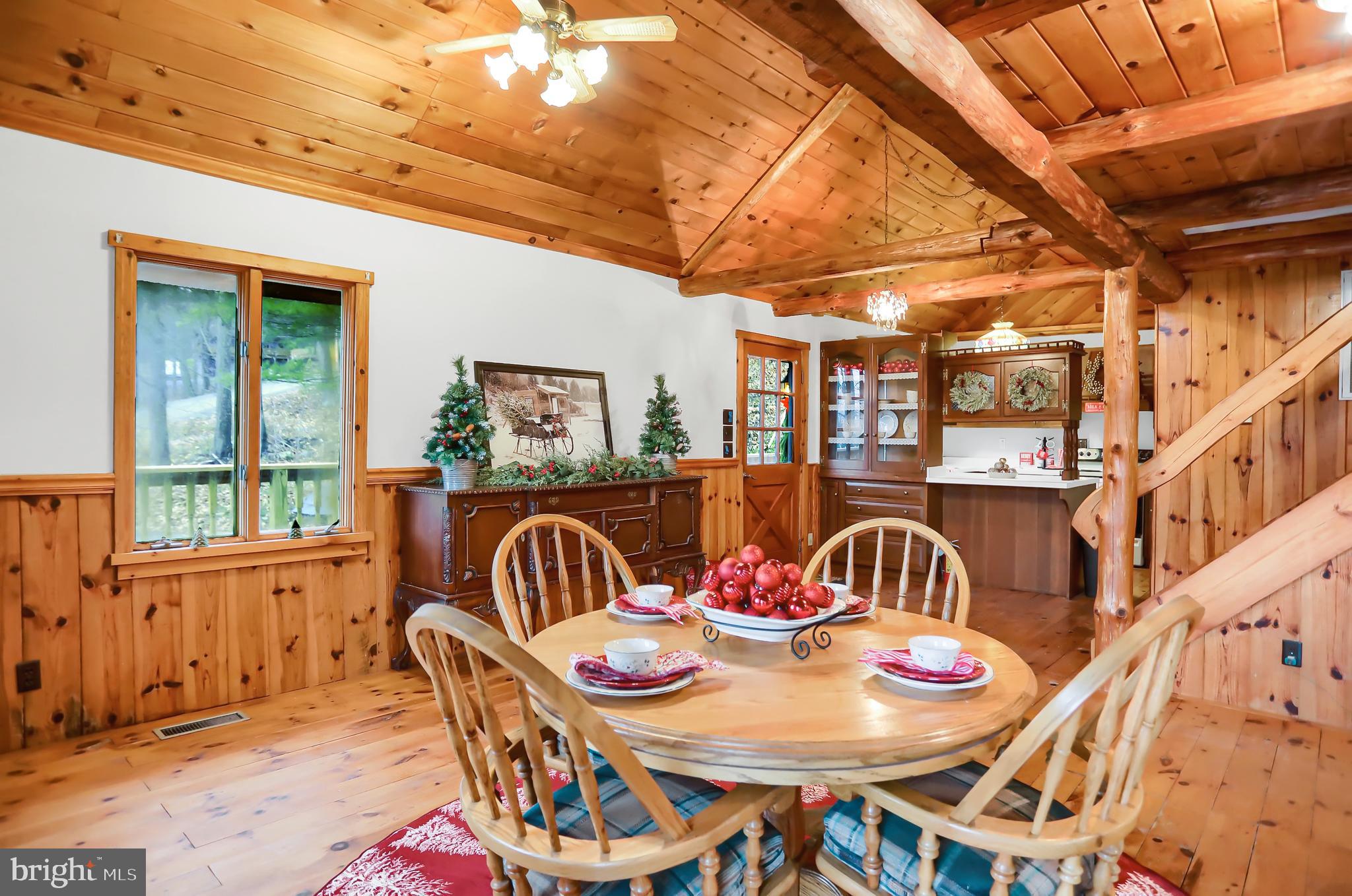 2716 Whitesel Road James Creek, PA 16657 - Photo 26 of 66 a view of a dining room with furniture a chandelier and wooden floor