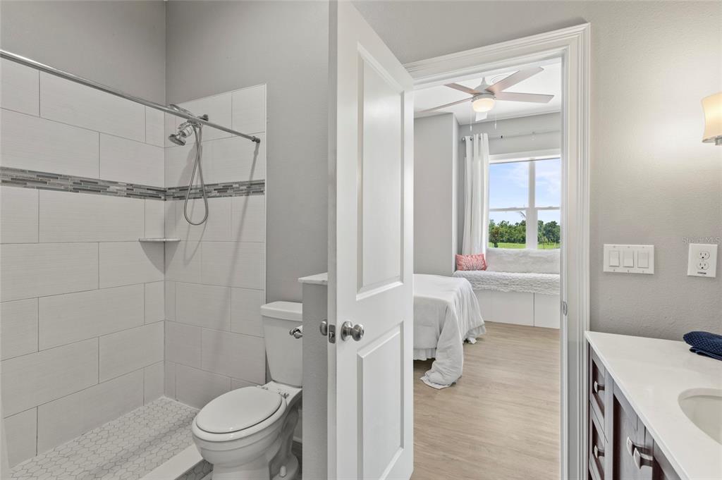 15710 Colding Loop Wimauma, FL 33598 - Photo 22 of 41 a bathroom with a sink a toilet and shower