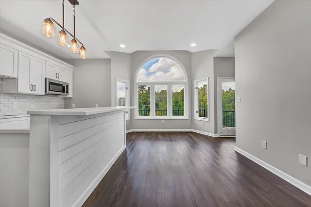 a view of backyard with a deck and wooden floor