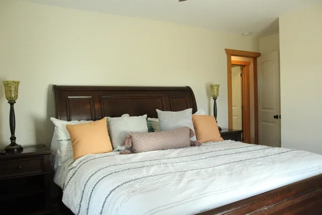 a bedroom with a bed and a night stand