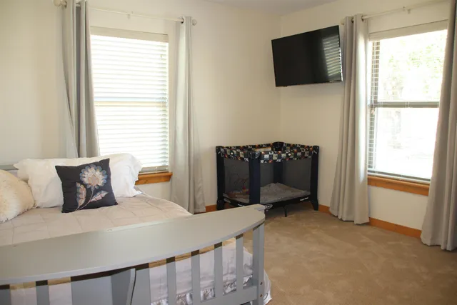 a bedroom with a bed and flat screen tv