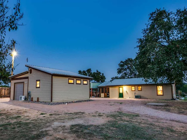 a view of a house with a yard and garage