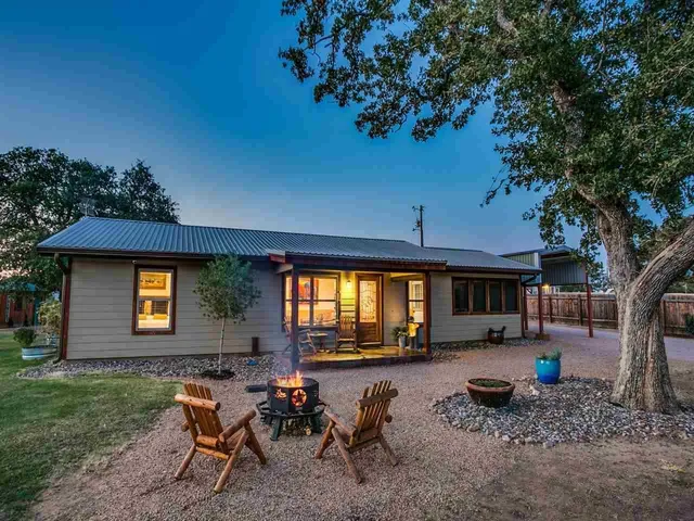 a backyard of a house with outdoor seating