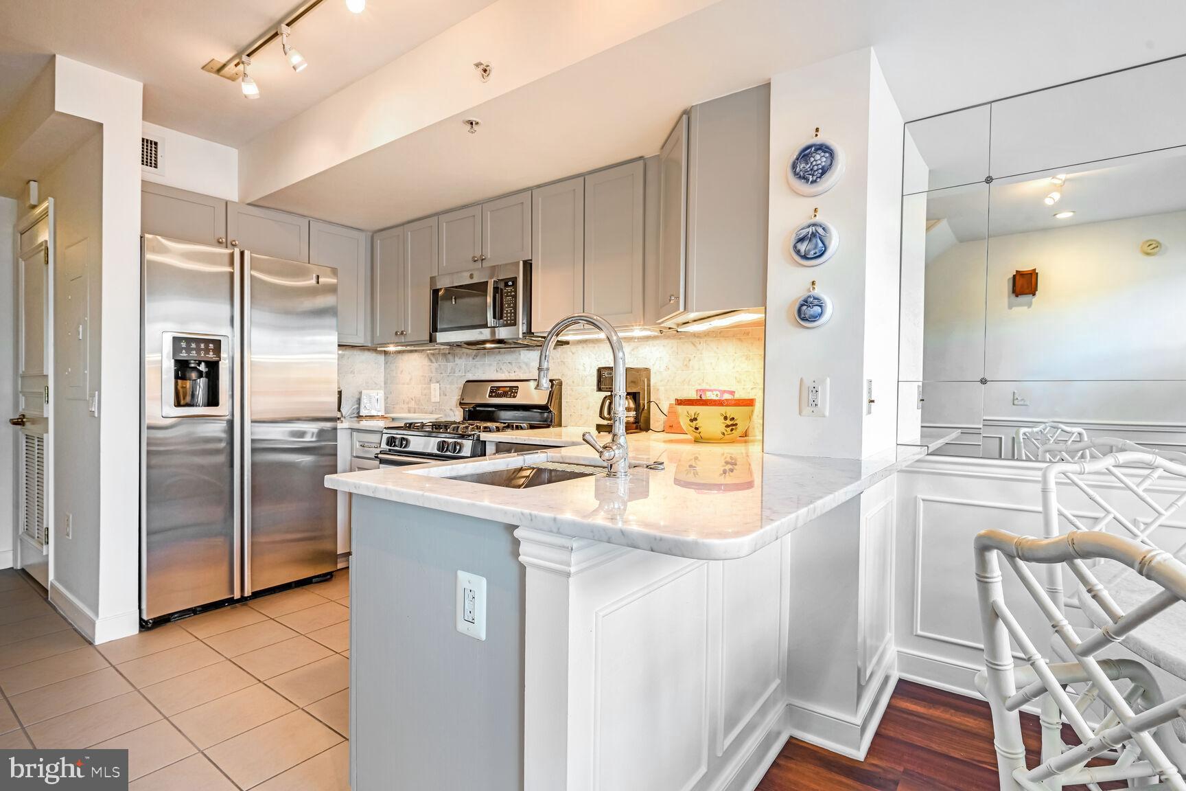 616 E Street Northwest, Unit 1150 Washington, DC 20004 - Photo 8 of 75 a kitchen with a sink appliances and cabinets