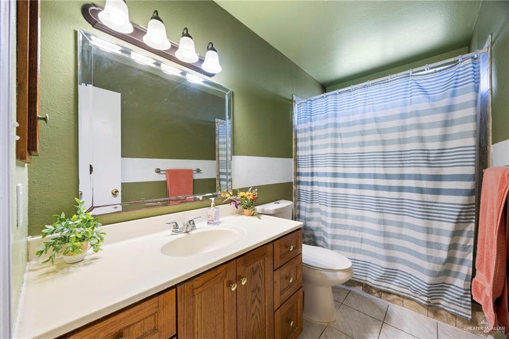 1124 Orange Street Mercedes, TX 78570 - Photo 8 of 17 a bathroom with a sink a toilet and shower