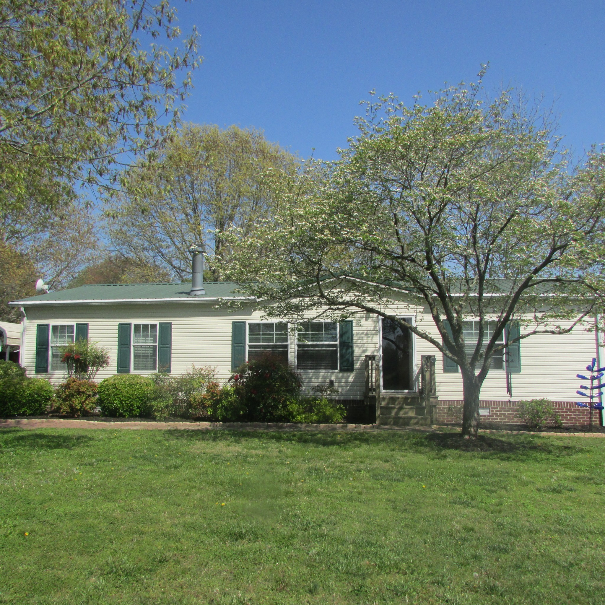 a front view of house with yard and green space